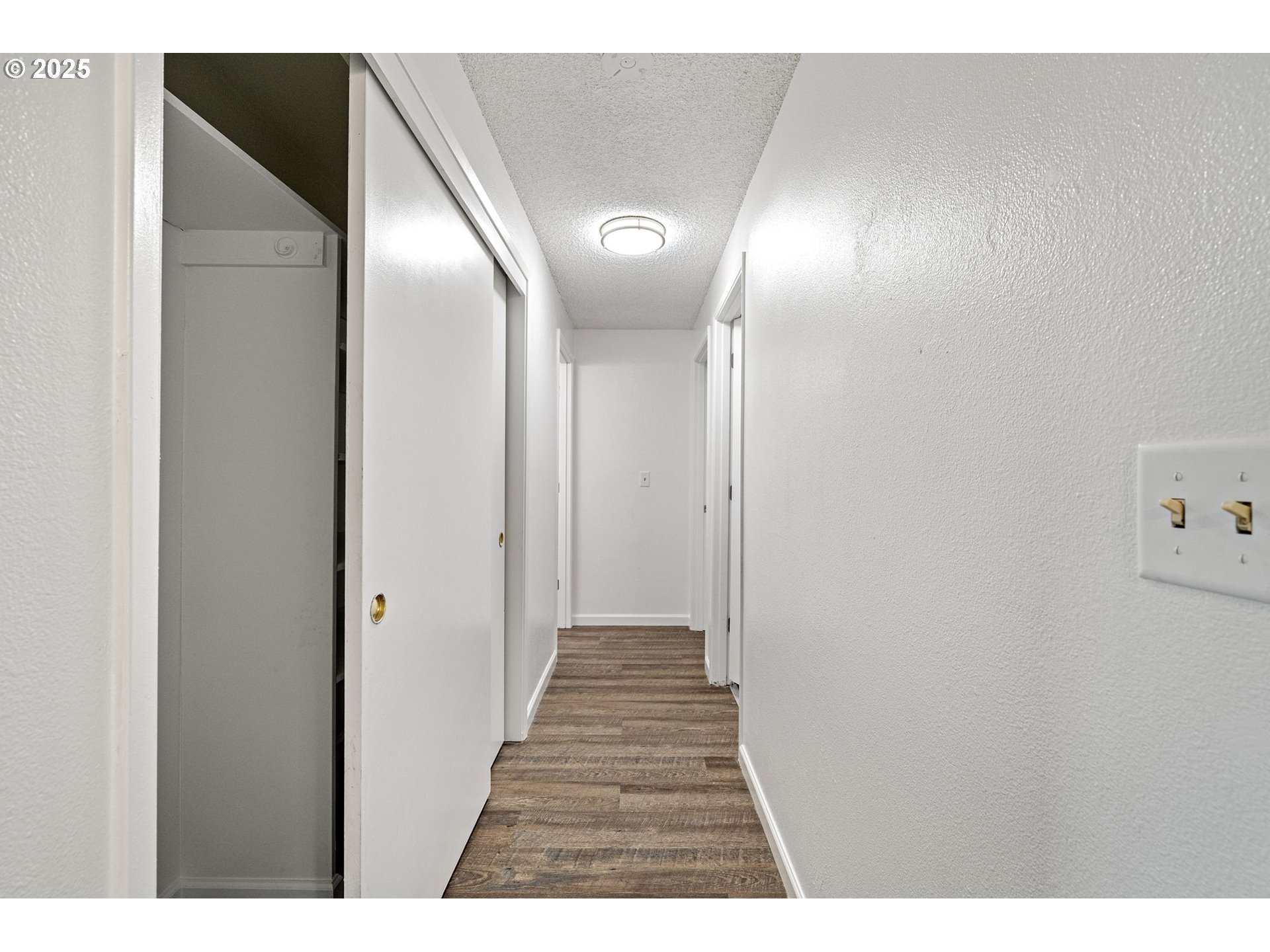 4883 Elderberry Loop Springfield, OR 97478 - Photo 13 of 23 a view of a hallway with wooden floor
