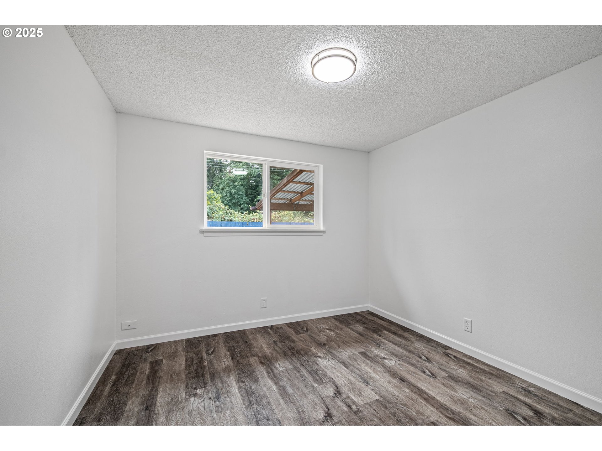 4883 Elderberry Loop Springfield, OR 97478 - Photo 14 of 23 an empty room with wooden floor and window