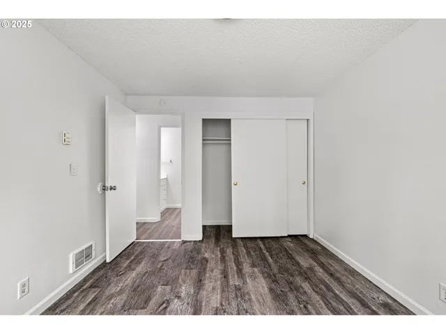a view of an empty room and wooden floor