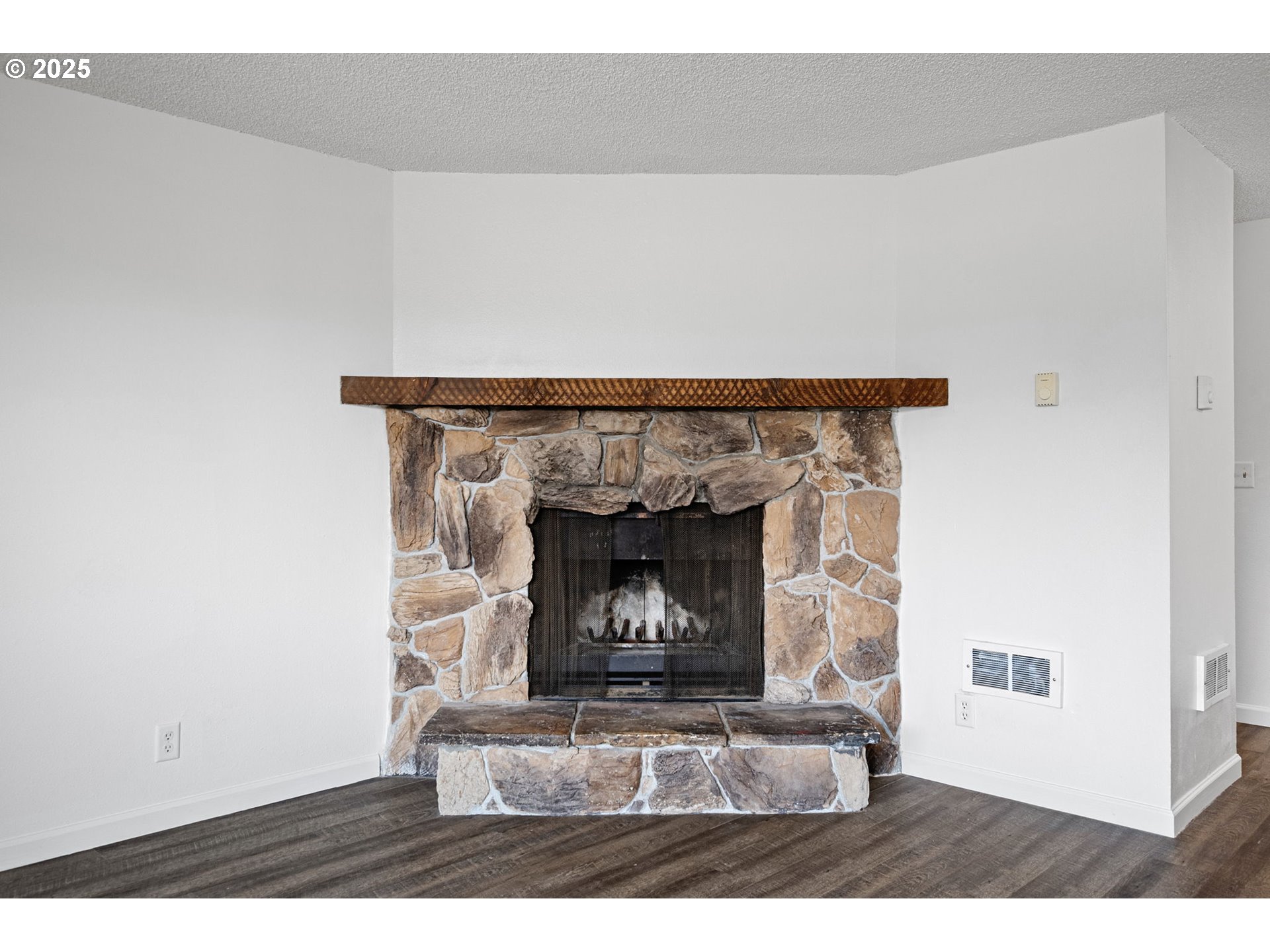 4883 Elderberry Loop Springfield, OR 97478 - Photo 6 of 23 a fireplace with a vase on top of it