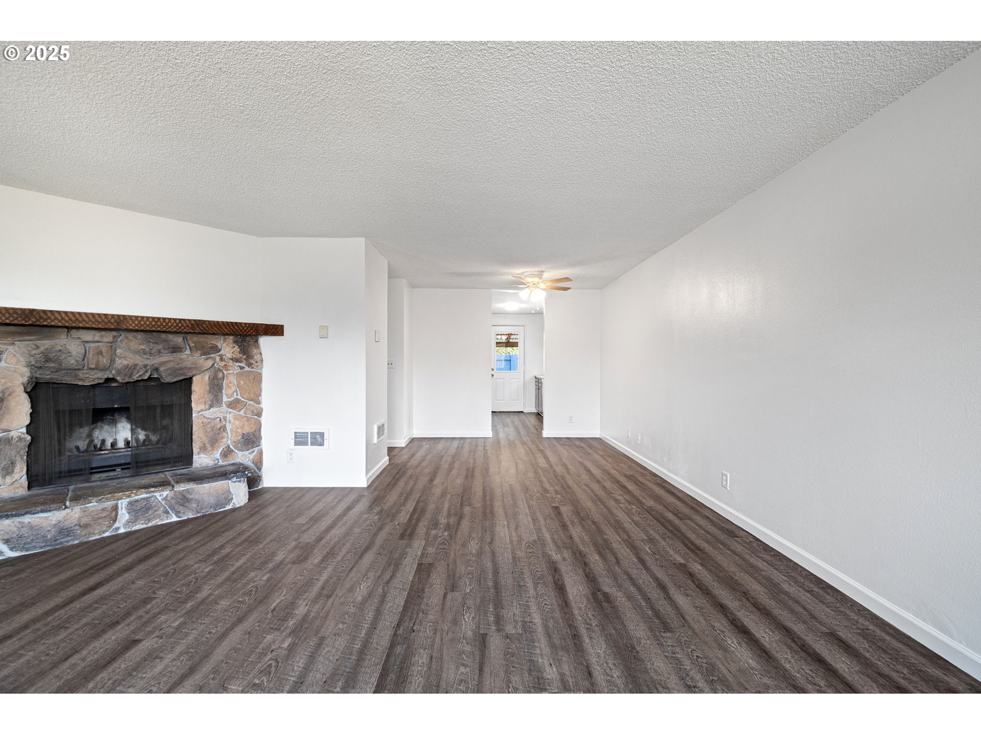 4883 Elderberry Loop Springfield, OR 97478 - Photo 7 of 23 a view of empty room with wooden floor and fireplace