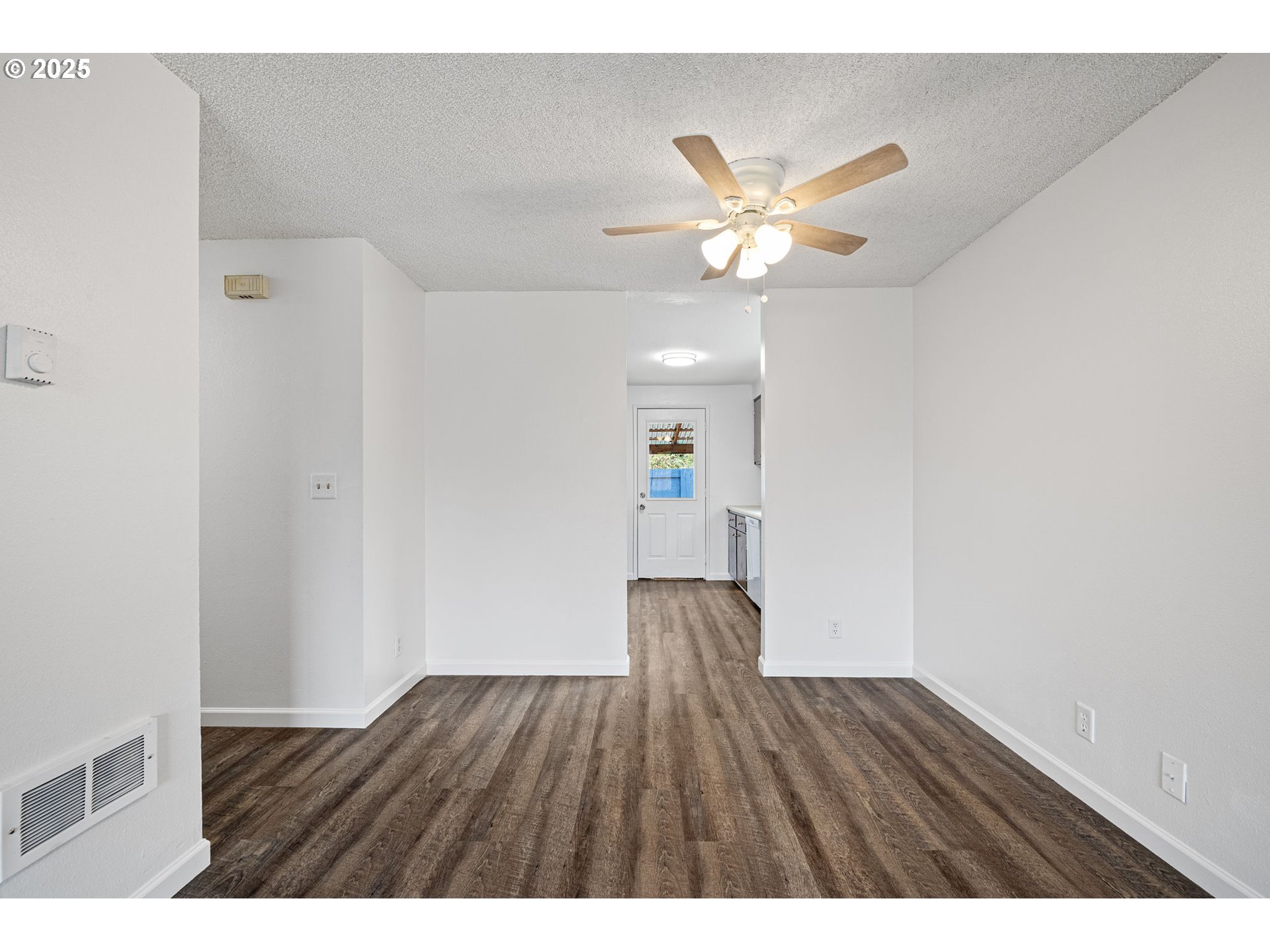 4883 Elderberry Loop Springfield, OR 97478 - Photo 9 of 23 a view of an empty room with wooden floor