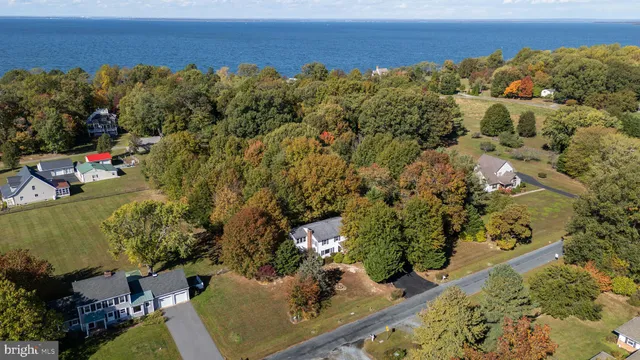 a view of a patio with table and chairs potted plants with wooden floor and fence