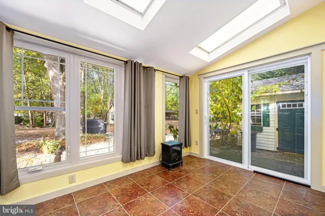 a view of kitchen with refrigerator and cabinets
