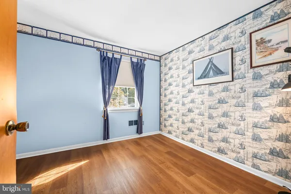 a view of a livingroom with wooden floor and a ceiling fan