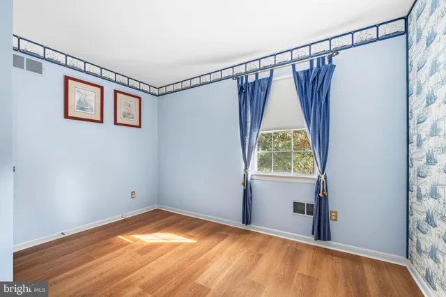 a spacious bedroom with a bed and a chandelier