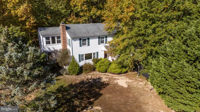 a front view of a house with a yard and potted plants