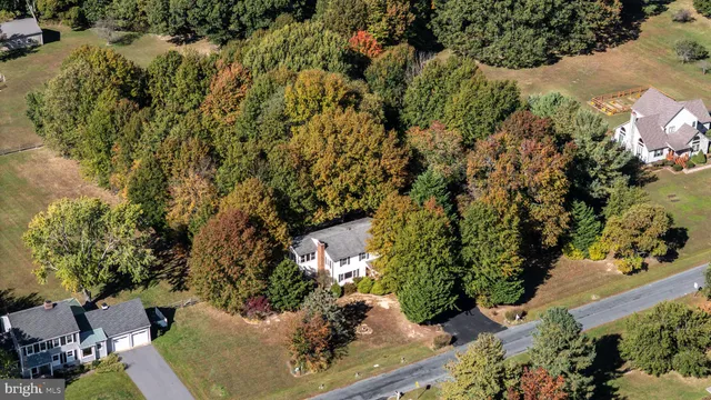 an aerial view of a house with a yard and lake view