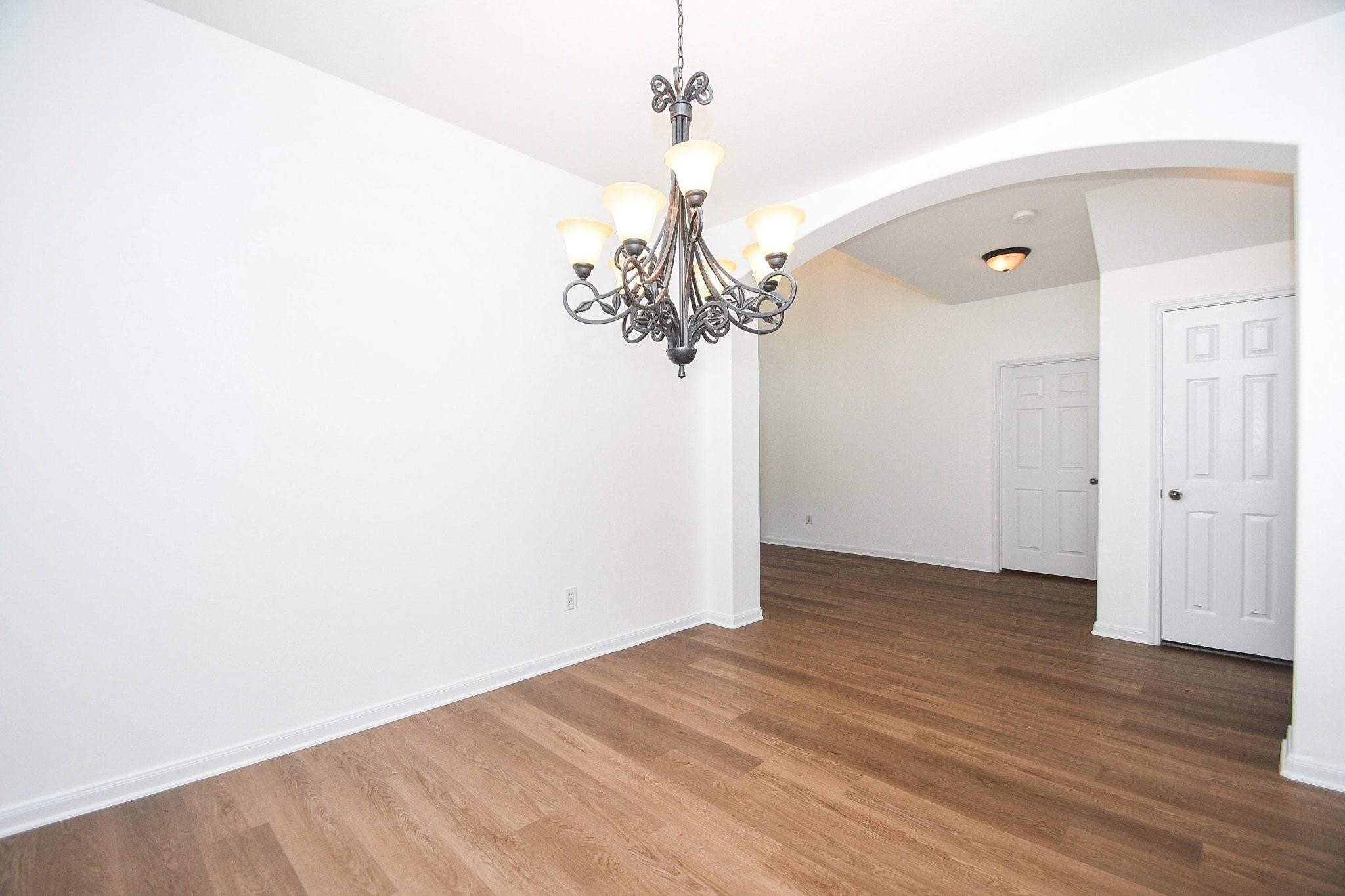 6927 Round Rose Court Spring, TX 77379 - Photo 9 of 37 Vinyl plank flooring and arched entrance complete this beautiful dinging area!