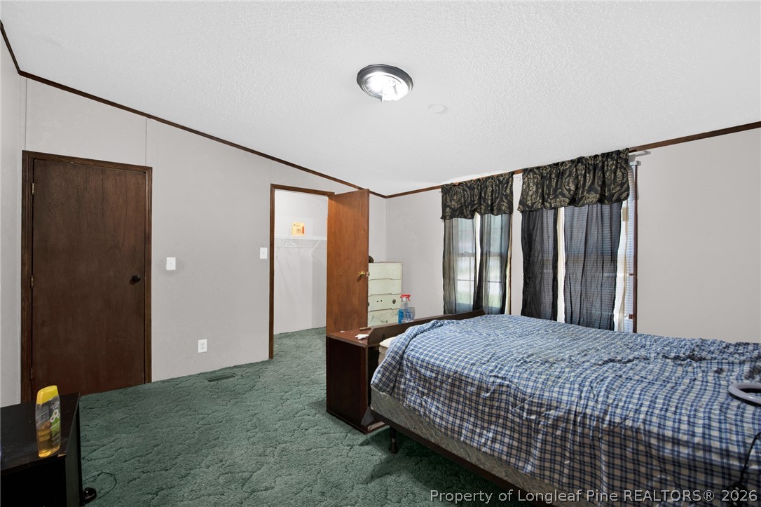 4705 Hickory Ridge Road Parkton, NC 28371 - Photo 20 of 37 a bedroom with a bed and a dresser