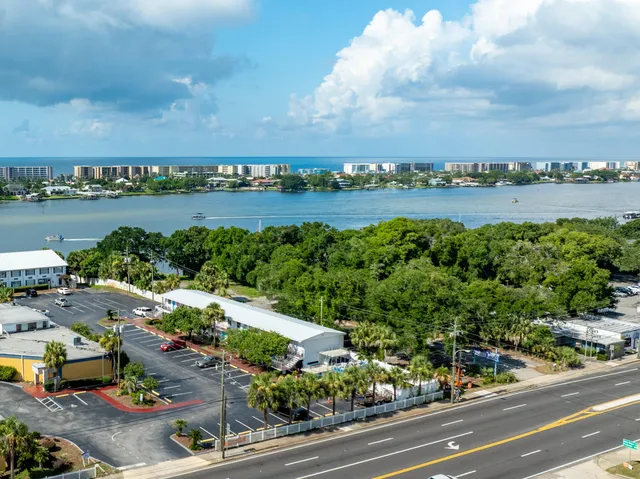 a view of a lake with lawn chairs