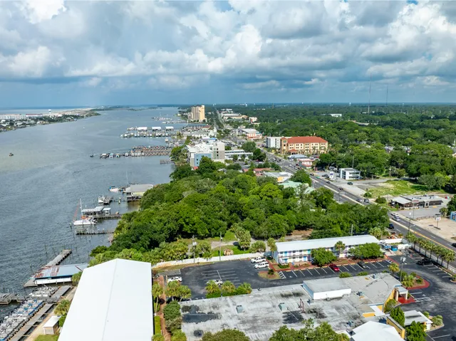 an aerial view of a house with a garden and swimming pool