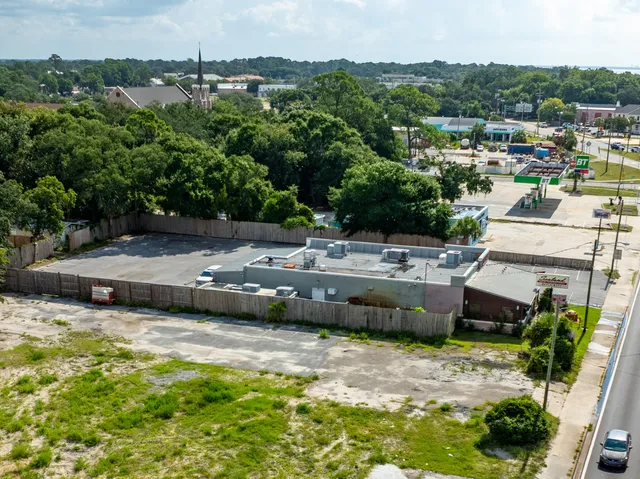 an aerial view of a houses with a yard