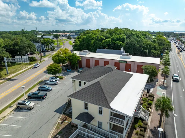 a front view of a building with car parked