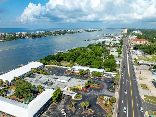 an aerial view of a house with swimming pool lake view and mountain view