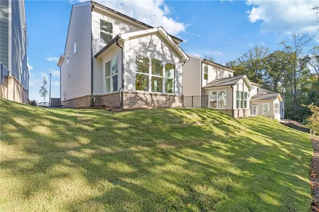 a view of house with a yard