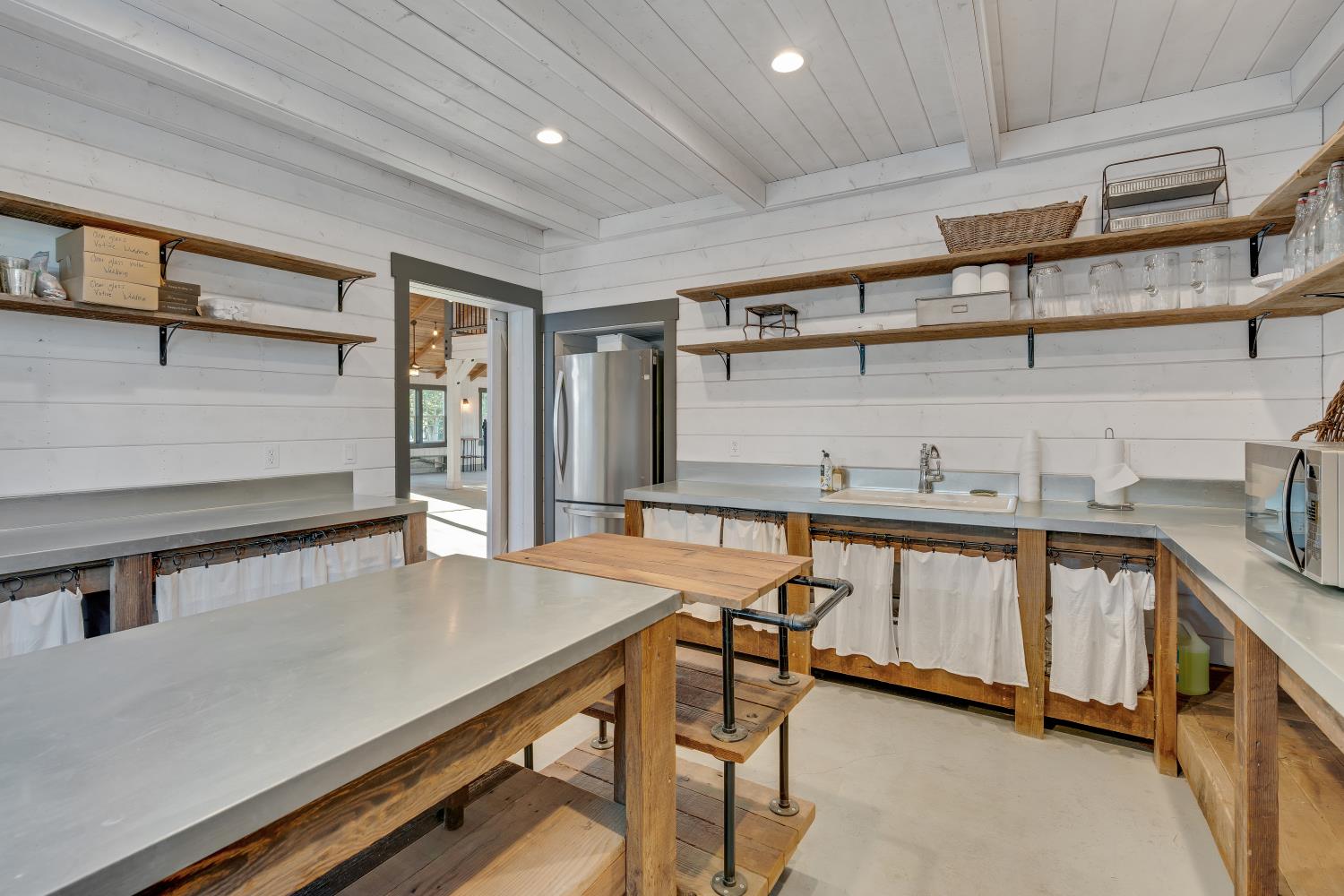 2905 Virginiatown Road Lincoln, CA 95648 - Photo 63 of 86 Event Barn Kitchen Prep Area- Utility space featuring shiplap walls, recessed lighting, metal counters, and wood-finish open shelving and Fridge