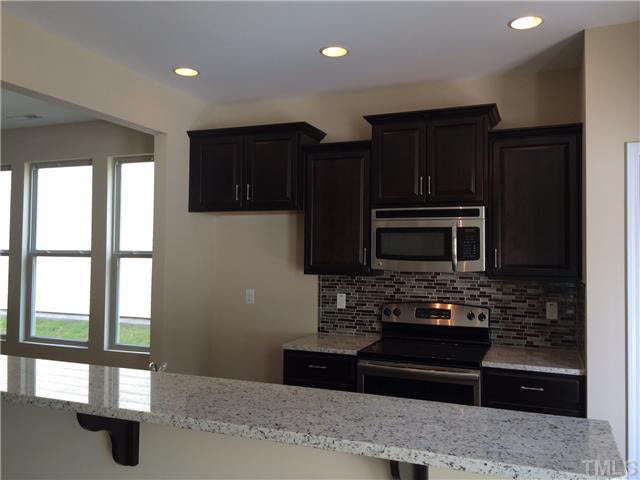 3713 Landshire View Lane Raleigh, NC 27616 - Photo 2 of 21 a kitchen with a refrigerator and a stove top oven