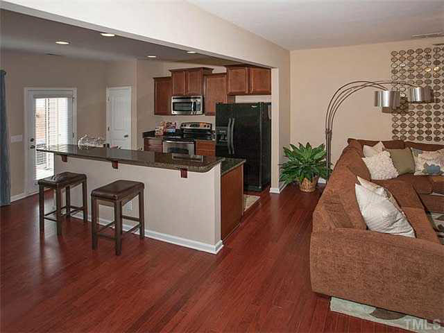 3713 Landshire View Lane Raleigh, NC 27616 - Photo 7 of 21 a kitchen with furniture wooden floor and a refrigerator