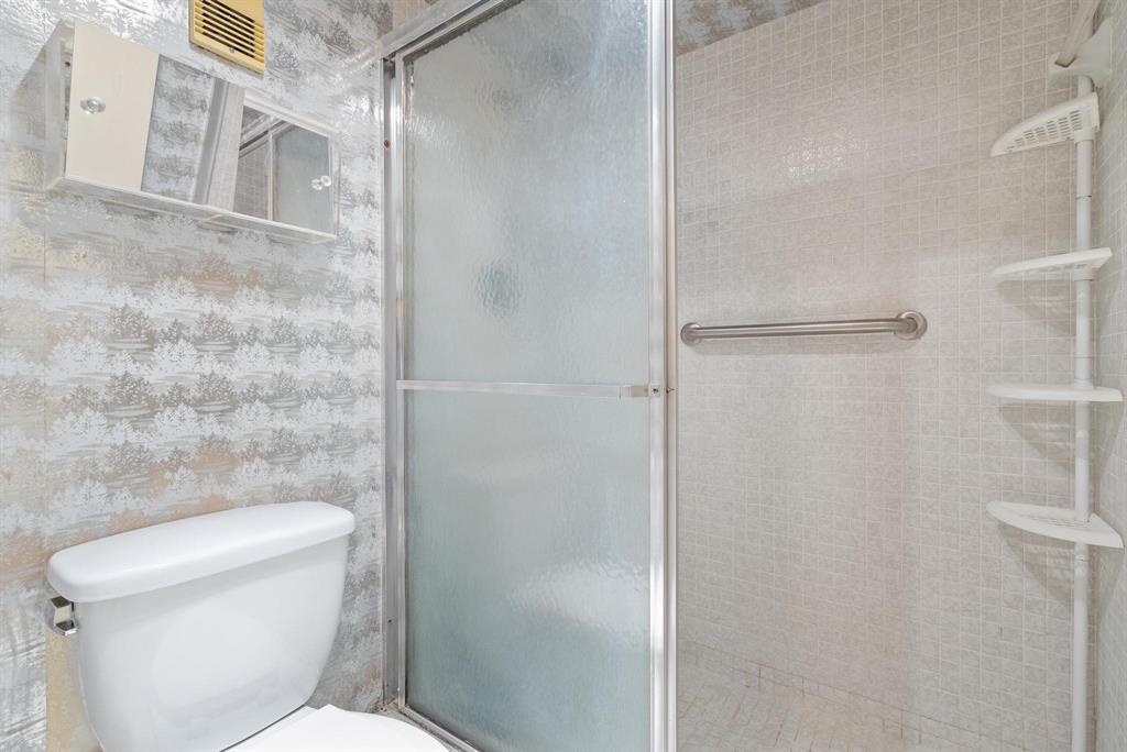 1200 St Charles Place, Unit PH7 Pembroke Pines, FL 33026 - Photo 16 of 28 a white toilet sitting next to a bathroom sink