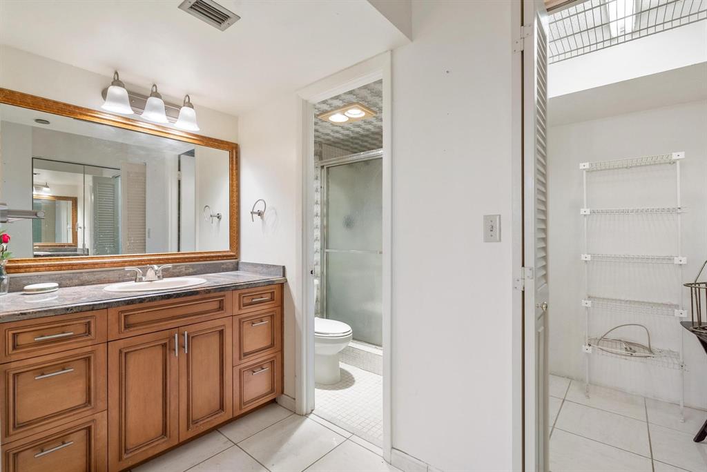 1200 St Charles Place, Unit PH7 Pembroke Pines, FL 33026 - Photo 17 of 28 a spacious bathroom with a granite countertop sink a toilet and a mirror