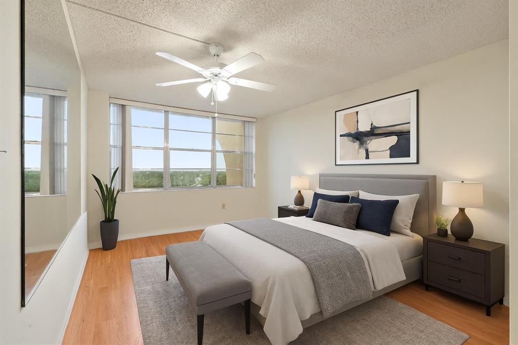 1200 St Charles Place, Unit PH7 Pembroke Pines, FL 33026 - Photo 18 of 28 a bedroom with a large bed and a window