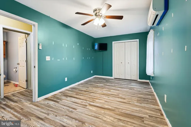 a bedroom with a bed and a ceiling fan