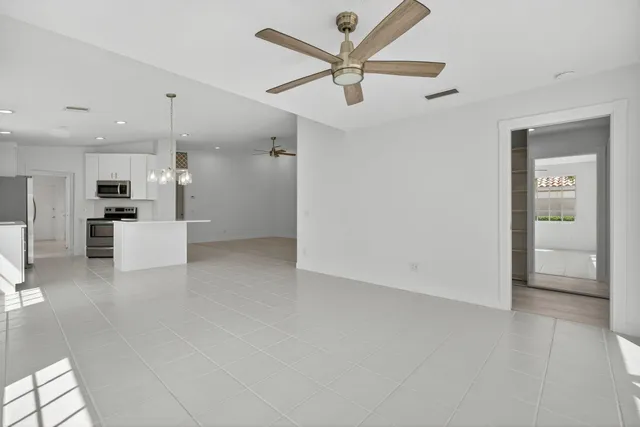 a view of a kitchen with a sink and stainless steel appliances