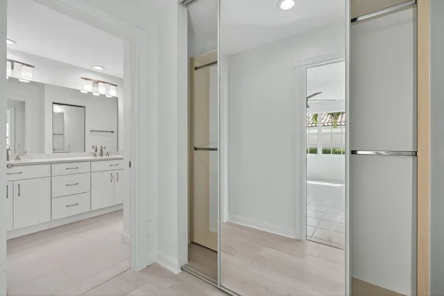 a spacious bathroom with a shower and a mirror