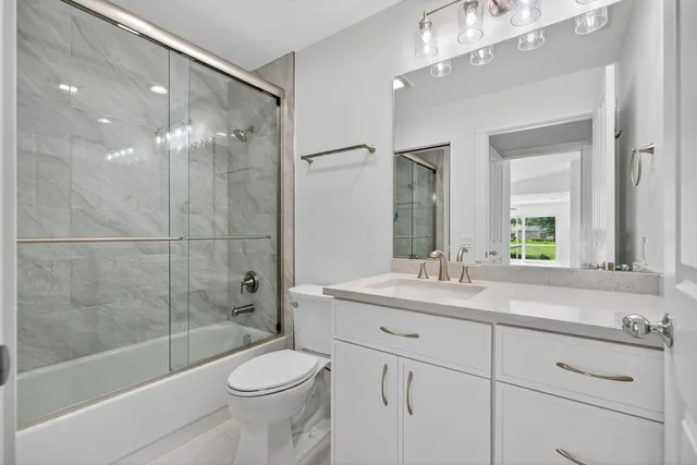 a utility room with cabinets washer and dryer