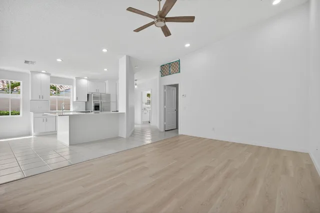 a view of empty room with projector and cabinet
