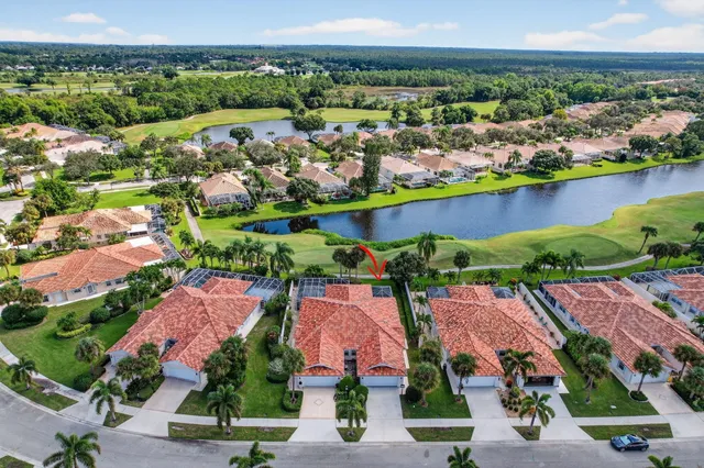 an aerial view of residential houses with outdoor space and swimming pool
