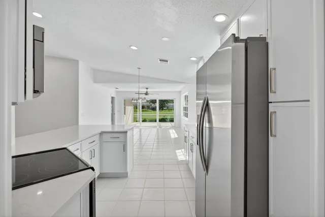 a view of kitchen with furniture and refrigerator