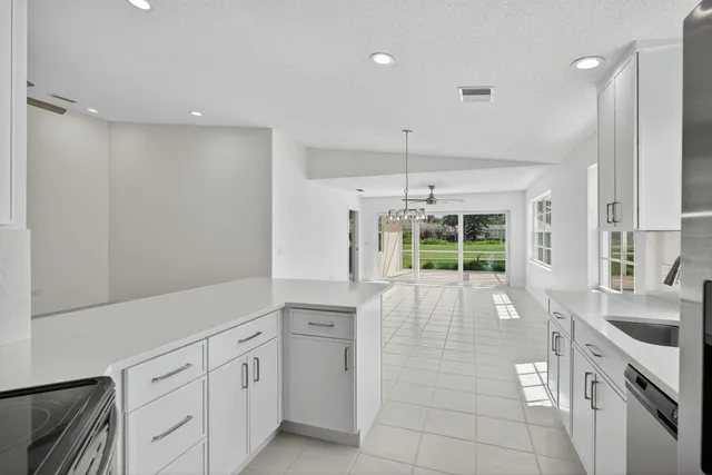 a large white kitchen with a large window