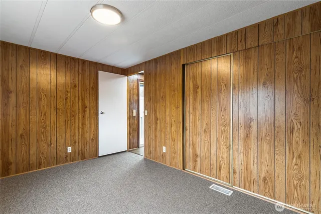 a view of an empty room with wooden walls
