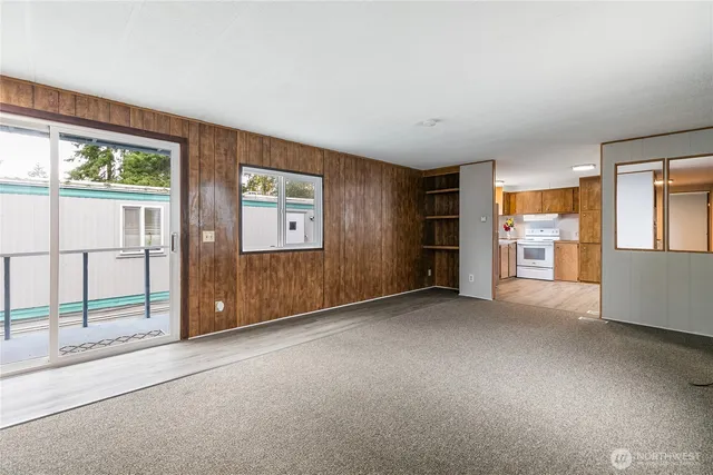 an empty room with furniture and windows