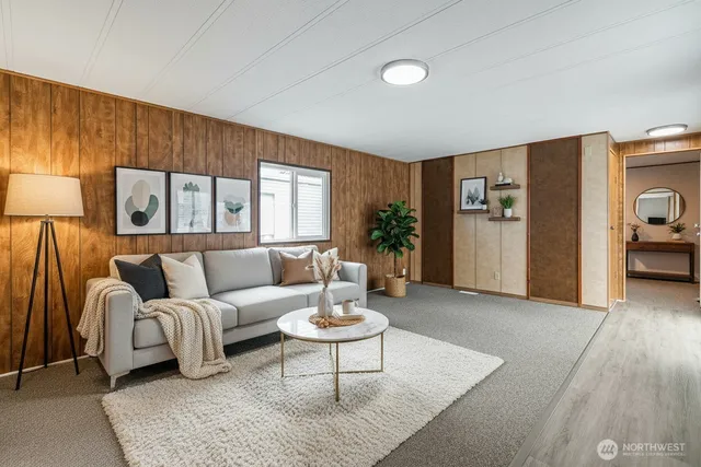 a living room with furniture and a potted plant