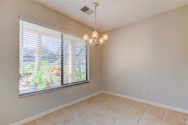 a view of a livingroom with a window and chandelier