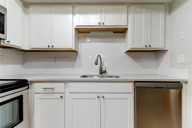 a kitchen with a sink and cabinets