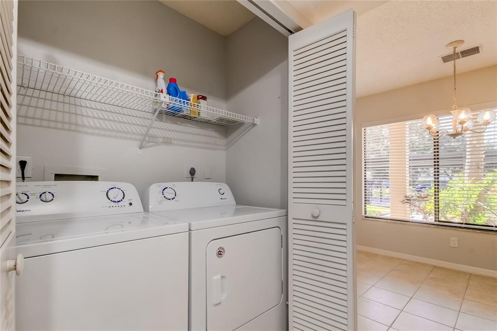1801 East Lake Road South, Unit 12C Palm Harbor, FL 34685 - Photo 24 of 24 a utility room with dryer and washer