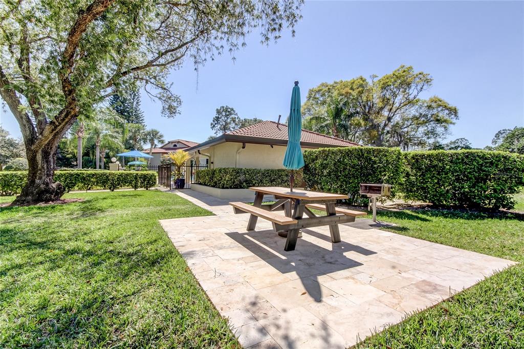 1801 East Lake Road South, Unit 12C Palm Harbor, FL 34685 - Photo 7 of 24 a view of a backyard with sitting area