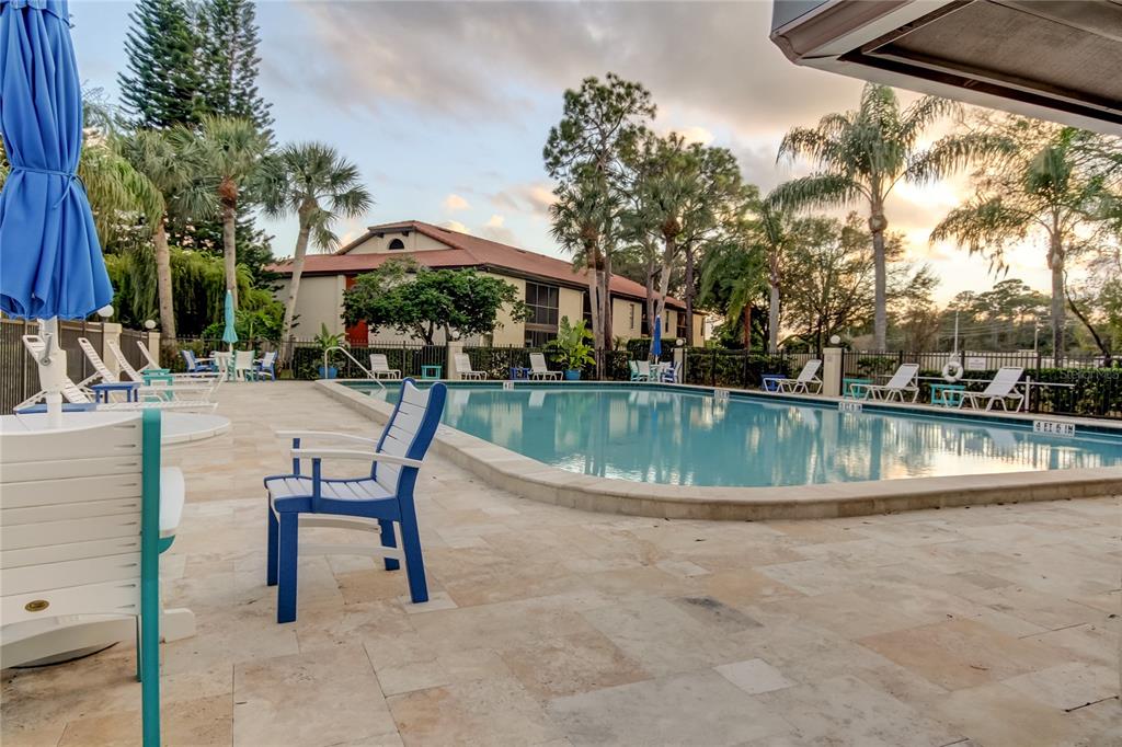 1801 East Lake Road South, Unit 12C Palm Harbor, FL 34685 - Photo 10 of 24 a view of lake with table and chairs under an umbrella