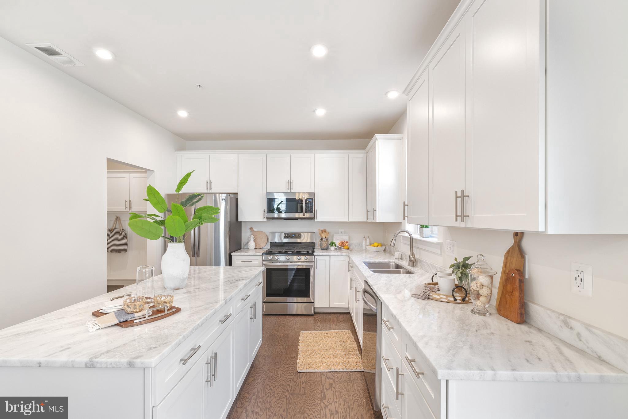 550 Broadneck Road Annapolis, MD 21409 - Photo 11 of 63 a kitchen with a sink stove cabinets and refrigerator