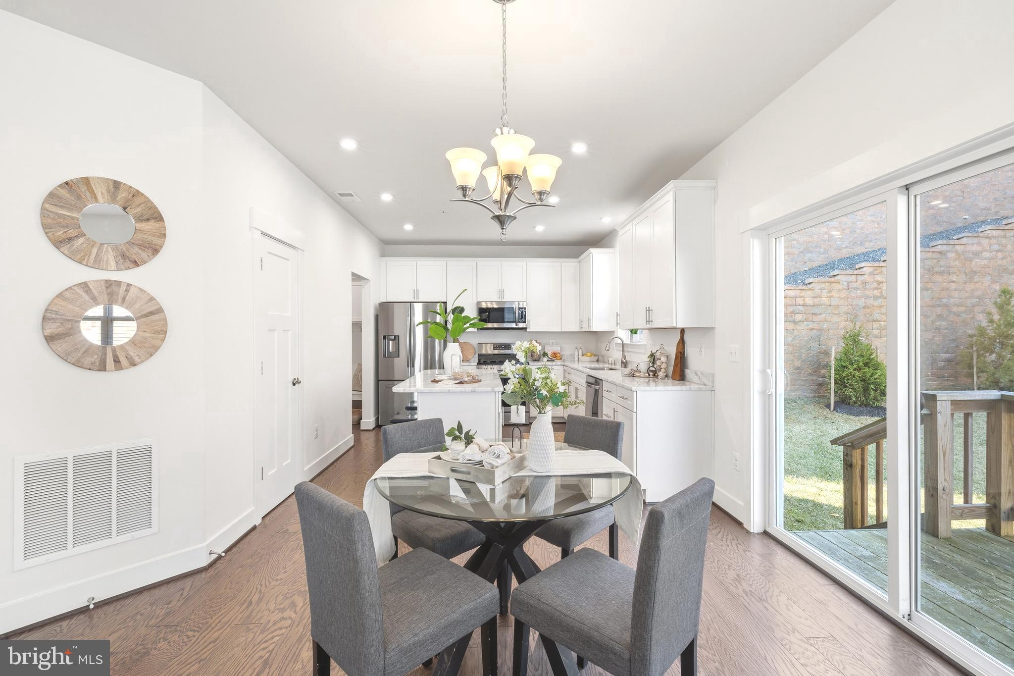 550 Broadneck Road Annapolis, MD 21409 - Photo 13 of 63 a view of a dining room with furniture a chandelier and wooden floor