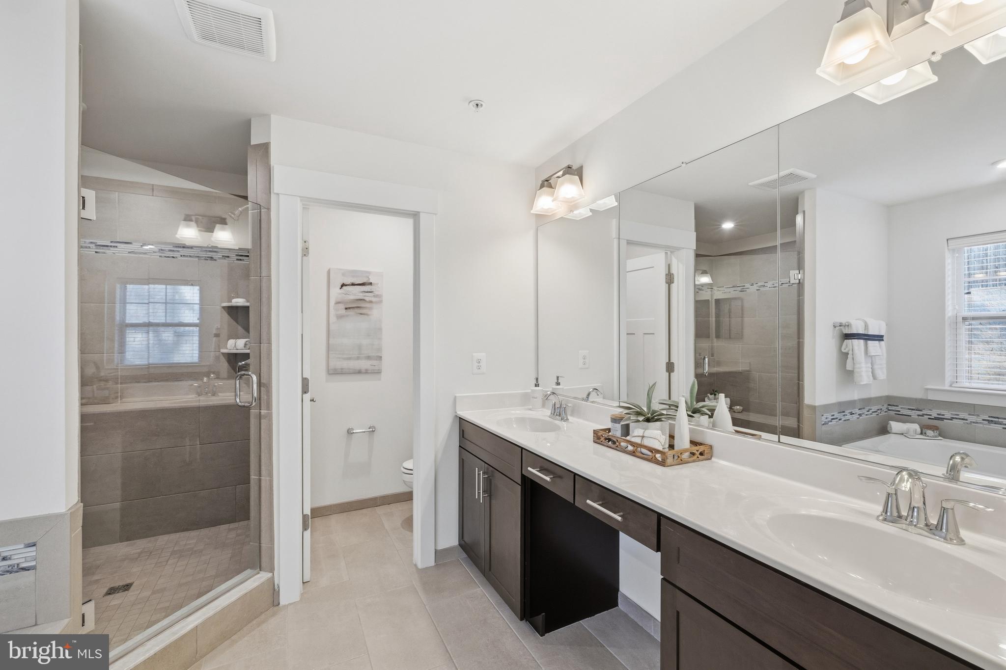 550 Broadneck Road Annapolis, MD 21409 - Photo 25 of 63 a bathroom with a double vanity sink mirror and shower