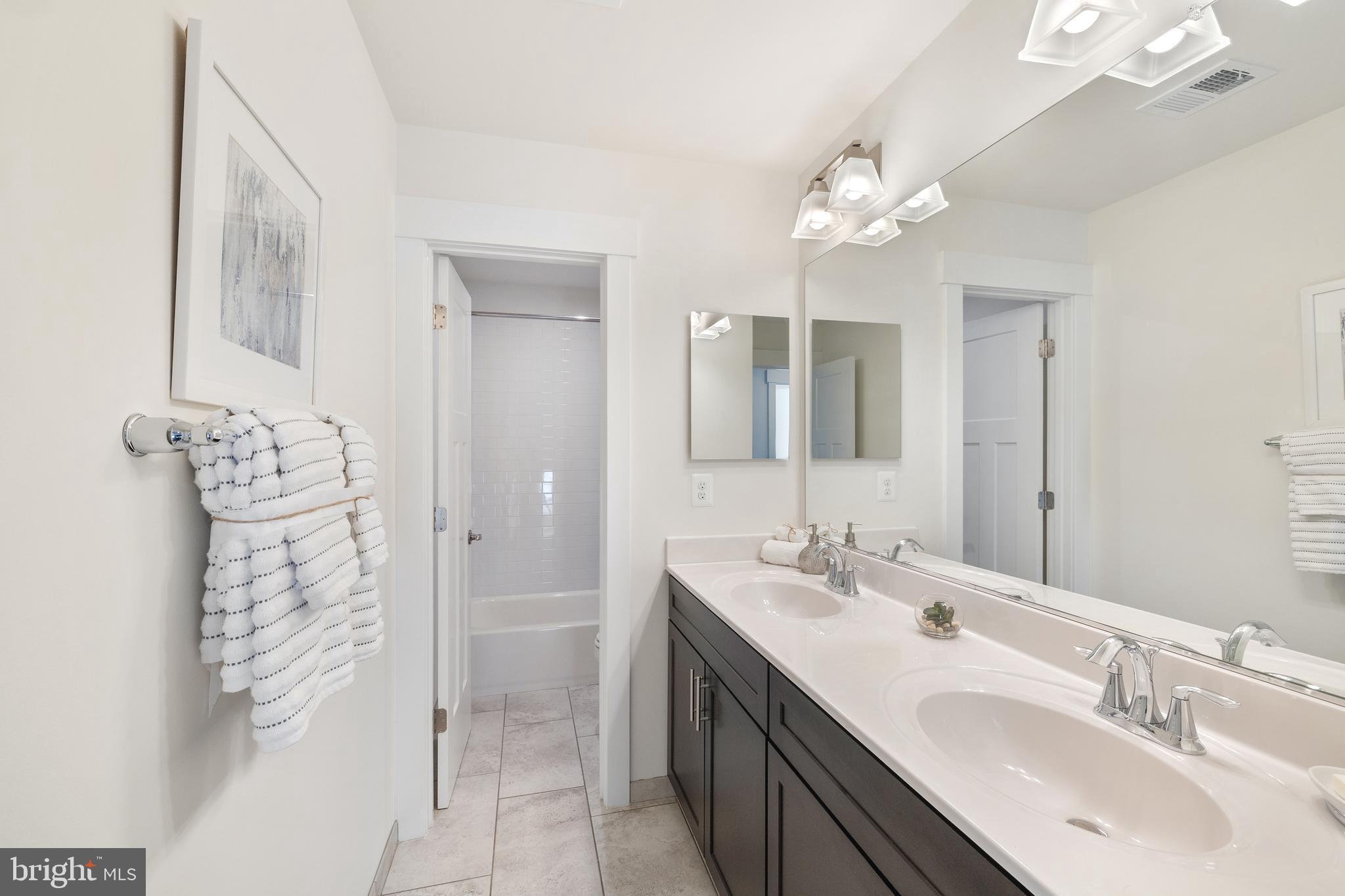 550 Broadneck Road Annapolis, MD 21409 - Photo 35 of 63 a bathroom with a sink vanity and a mirror