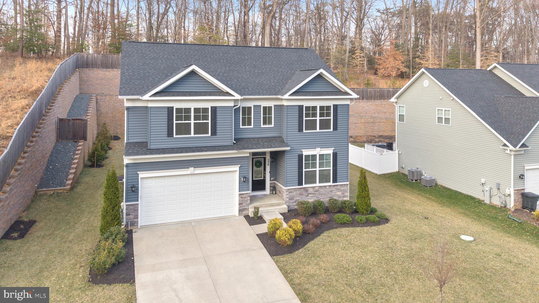 550 Broadneck Road Annapolis, MD 21409 - Photo 62 of 63 a view of a big house with a small yard and large tree