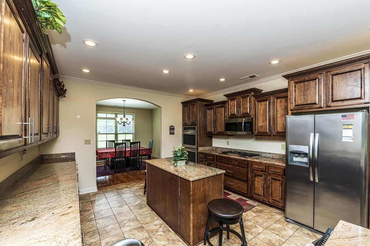 185 Belmont Road Mason, TN 38049 - Photo 2 of 40 a large kitchen with kitchen island granite countertop a large counter top stainless steel appliances and cabinets