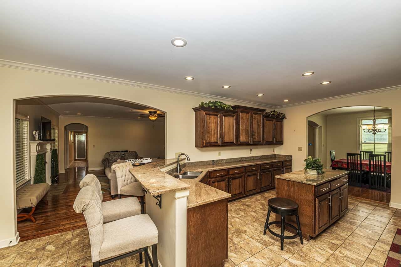 185 Belmont Road Mason, TN 38049 - Photo 21 of 40 a living room with stainless steel appliances furniture a rug and a kitchen view