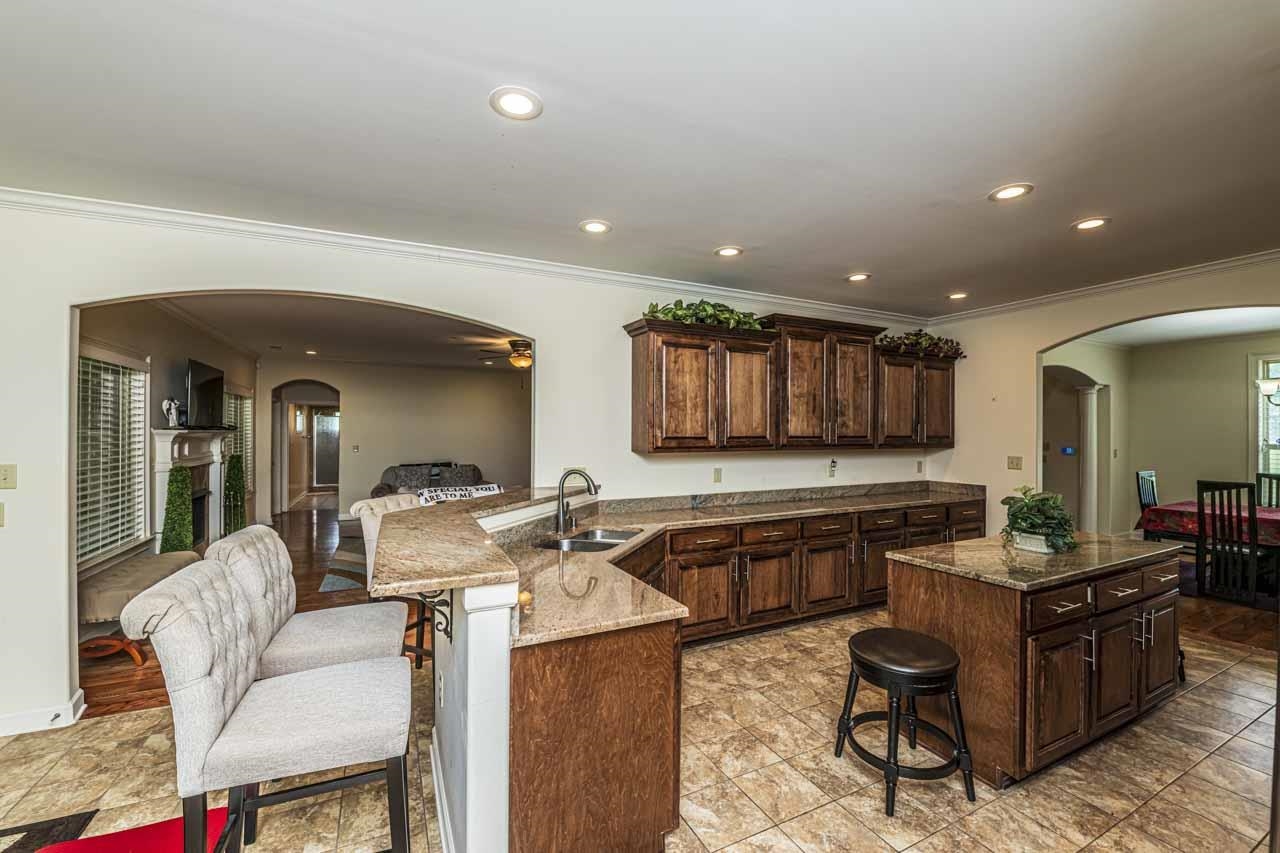185 Belmont Road Mason, TN 38049 - Photo 22 of 40 a living room with furniture a wooden floor and kitchen view